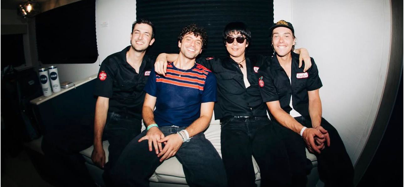 Band backstage, smiling
