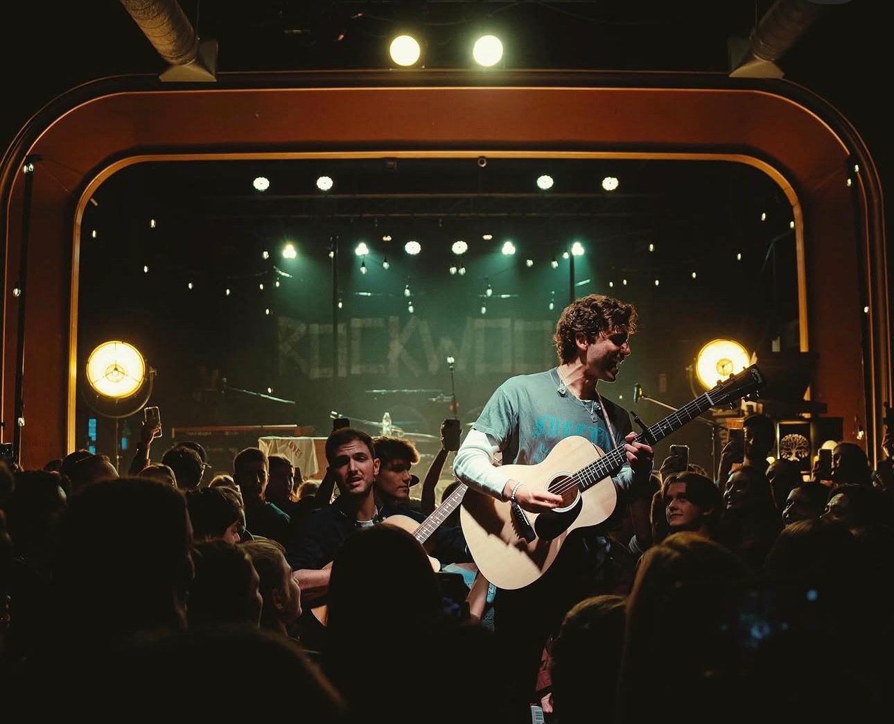 Mark with guitar inside the crowd